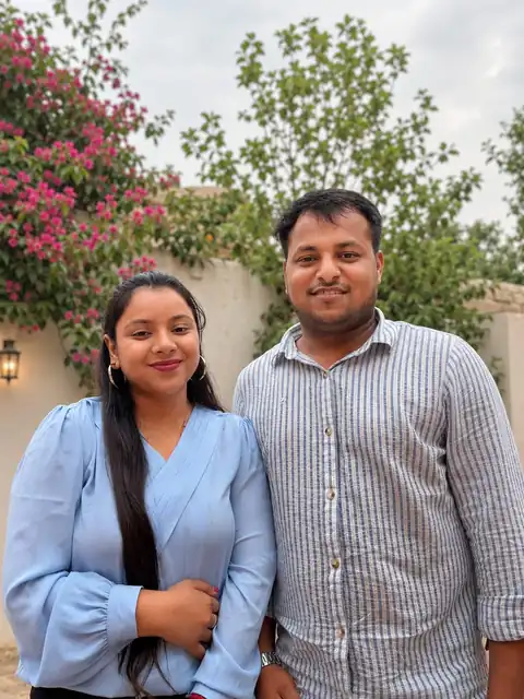 Sweety and Ripul smiling together in a garden